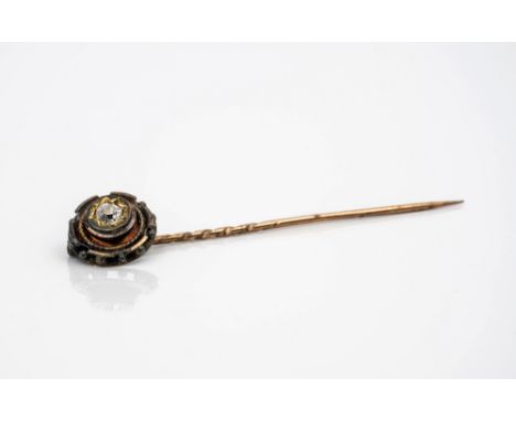 A late Victorian 18ct gold and diamond stick pin, the floral pin with beaded borders, centred with a single star-set cushion 