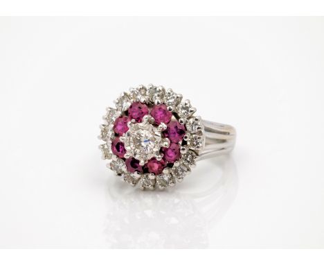 An 18ct white gold, ruby and diamond cluster ring, the central 0.20ct star-set brilliant cut diamond over two tiers of round 