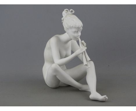 Kaiser German porcelain figure of a seated girl playing panpipes