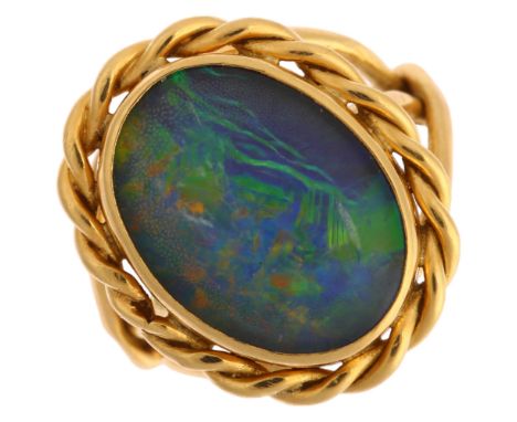 A late 20th century 18ct gold opal triplet ring, with rope twist surround and shank, maker's marks AMN, London 1974, setting 