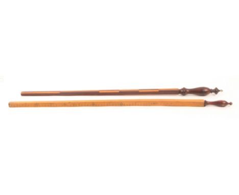 Two measuring sticks, comprising a Dutch Ell, the turned handle to a tapering square section in mahogany, two sides marked in