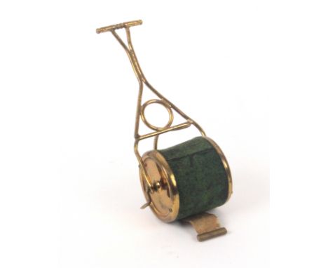 A gilt brass novelty tape measure in the form of a garden roller, complete printed tape in ins and cms, wound from the side, 