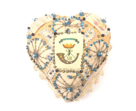 A regimental heart shaped pin and bead stuck pin cushion, with silk for Prince Albert's (Somerset Light Infantry), 18cms. 