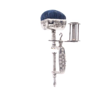 A cut and polished steel multiple sewing clamp, the ornamental rectangular frame with open heart screw terminal below a platf