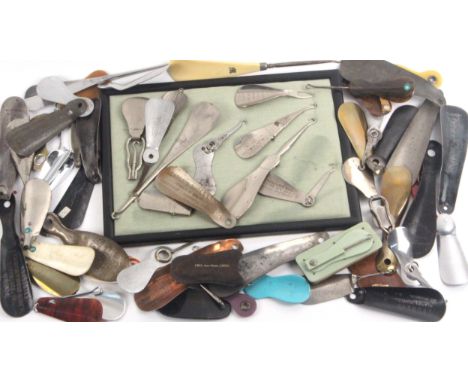 A collection of fifty five shoe horns, mostly metal incorporating adverts, some with button hooks including a group mounted i