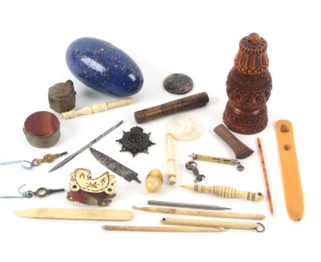 A mixed lot, comprising a coquilla pepper or sander, 10.5cms, a speckled blue wooden egg containing a paper snake, 9.5cms, tw