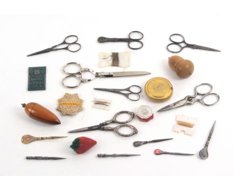 A mixed lot - sewing, comprising seven pairs of scissors, one pair with silver arms and loops, largest 14cms, five steel stil