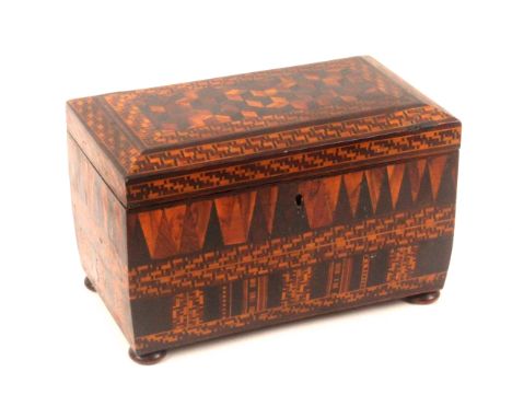 An unusual and intensely decorated Tunbridge ware tea caddy, of sarcophagol form raised on bun feet, the canted top with a pa