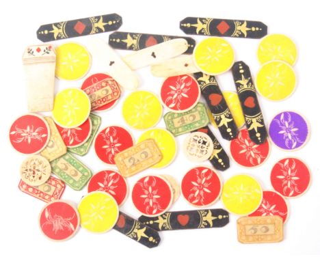 A collection of French gaming counters and playing card related items, comprising eight black painted card markers of cut cor
