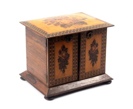 A good Tunbridge ware rosewood table cabinet, the cushion form overhanging top inset with a mosaic panel of flowers and leave