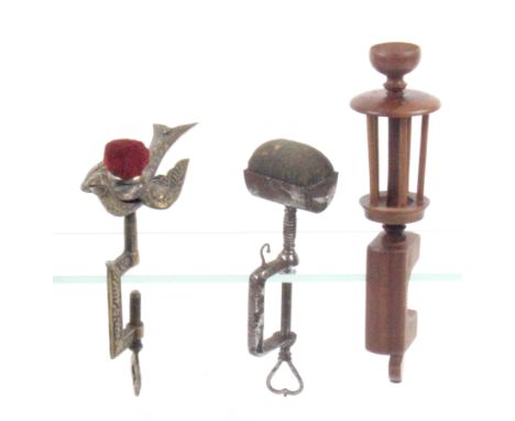 Three sewing clamps, comprising a brass hemming bird example, the floral decorated rectangular frame below a sprung bird with