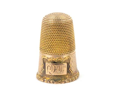 A 19th Century gold thimble, unmarked, the engine turned frieze with a fancy cartouche with raised tablet initialled 'BW'? ov
