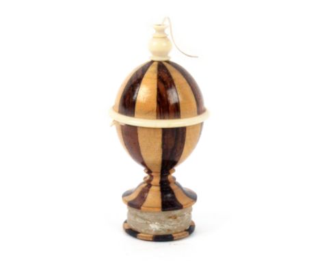 A French silk ball holder / waxer of vase form, in alternate light and dark wood segments with bone mounts, the circular foot
