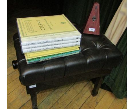 A concert adjustable piano stool in bright ebonised finish with buttoned leather top;   together with a quantity of music and