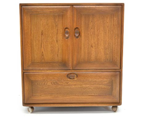 Ercol elm television/media cabinet, the two hinged doors enclosing storage space, with sliding door feature, above a further 