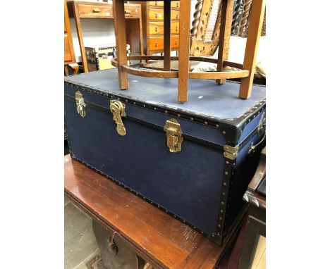 A metal bound blue travel trunk 