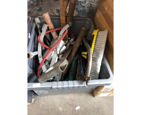 A box of tools including a foot pump, saws, etc 
