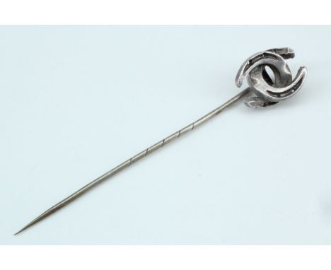 A Victorian stick pin with interlocking horseshoes terminal