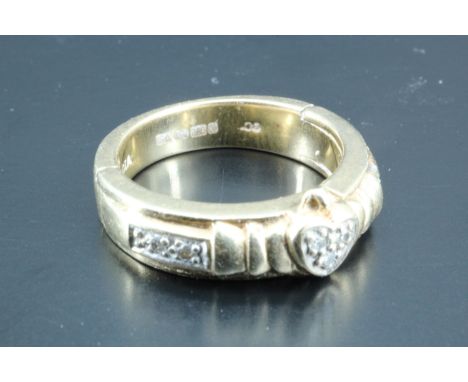 A contemporary diamond-set claddagh-inspired ring, comprising a heart-shaped setting of small diamonds clasped between styliz