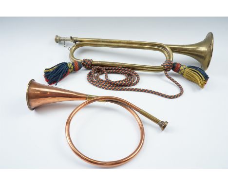 A 1960s British army cavalry bugle together with a copper hunting horn