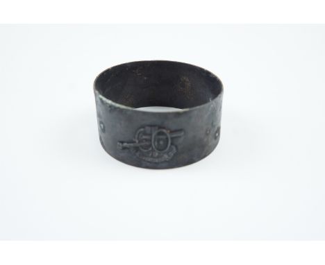 A Great War French patriotic napkin ring, faced with a representation of a 75 mm artillery piece with legend "1914 - 1915"