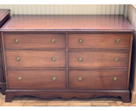 A reproduction Georgian chest of three pairs of short drawers, having circular flowerhead stamped brass back-plate ring handl