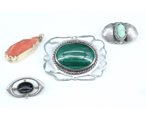 Three vintage brooches and a pendant, variously comprising mounted malachite, jade and coral specimens respectively set in re