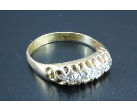 A vintage five stone diamond ring, comprising five small graded diamond brilliants gallery-set on high carat yellow metal , (