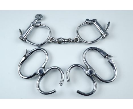 Vintage Hiatt handcuffs together with two sets of Hiatt wrist restraints