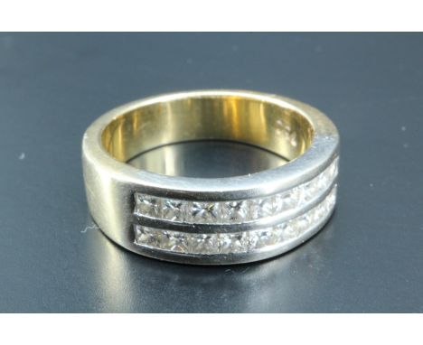 A diamond half hoop eternity ring, having two rows of nine channel set princess cut diamonds (approximately 0.35 carat), the 