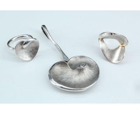 Two contemporary rings and a pendant, having naturalistic leaf form and a mat textured finish, the pendant accentuated with a