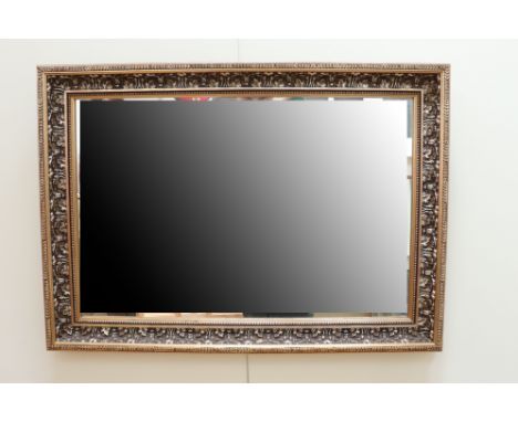 An antiqued-gilt framed oblong wall mirror, 75 cm x 58 cm