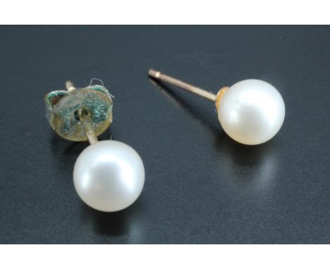 A pair of yellow metal mounted pearl stud earrings, pearls 5 mm, mounted testes as gold