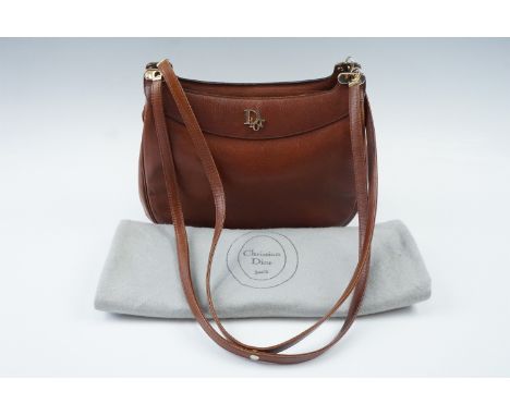 A Christian Dior brown leather handbag with original storage bag