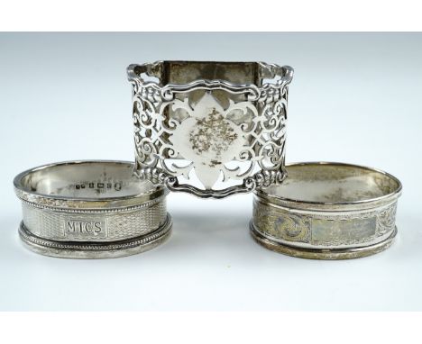 An Edwardian pierced silver napkin ring, having a vacant lozenge to the top and a flat base, Birmingham, 1915, together with 