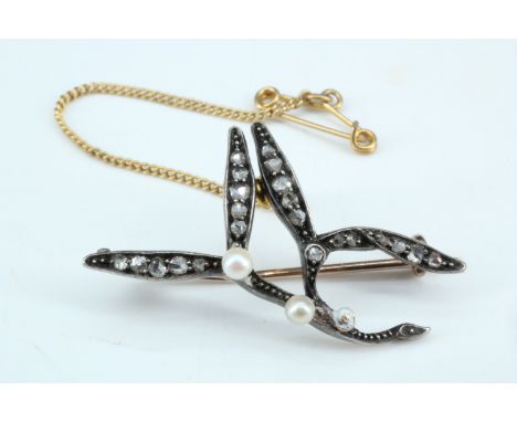 A late 19th / early 20th Century romantic mistletoe sprig brooch, having pearl berries and leaves set with graded rose cut di