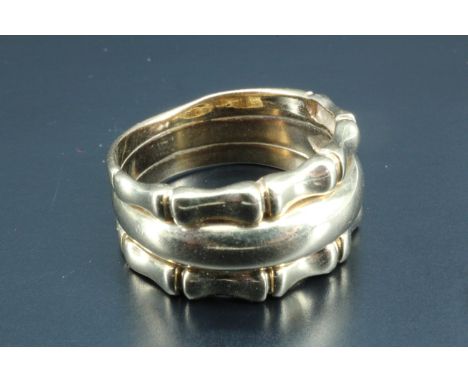 A lady's 9 carat gold tripartite ring, being a concave tapering central band between two bamboo effect bands, Birmingham, 200