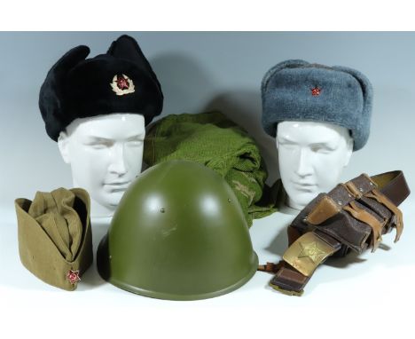 A quantity of Soviet Bloc military clothing and kit including a helmet, camouflage oversuit, belt and ammunition pouches