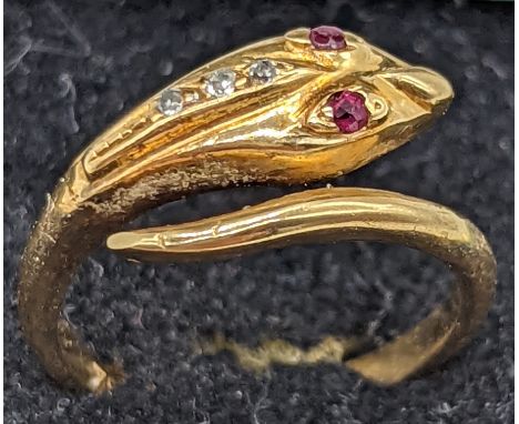 An 18ct gold snake ring, ruby eyes and 3 mounted diamonds, 3.3g