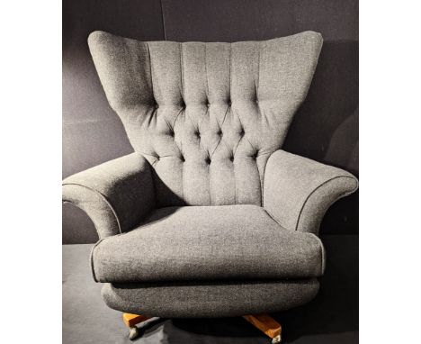 An Orbit 20th century button back swivel chair, grey upholstery, raised on X-stretcher and casters, stamped to casters, G-pla