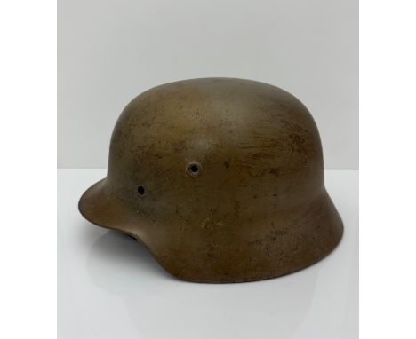 A WWII Norwegian used  German M40 steel helmet clearly marked ET66 to side inner rim, 314 to back inner rim. .  With original