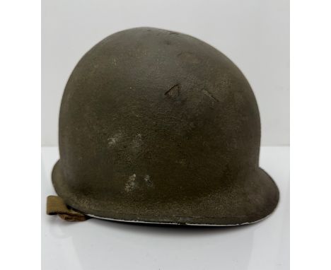 Complete original WWII US Helmet. Indistinct number to inner rim on helmet shell, possibly 0077. Liner inscribed to front TSg
