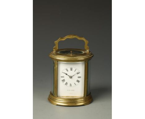 ASPREY LONDON: A FRENCH OVAL BRASS CASED REPEATING CARRIAGE CLOCK, the white enamel dial with Roman numerals, inscribed 'Aspr