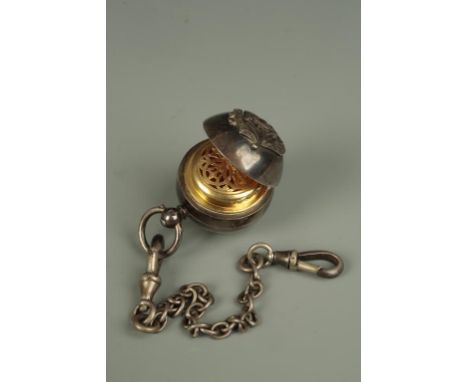 A VICTORIAN SILVER AND SILVER GILT ROUND FOB decorated to the exterior with conjoined initials, fitted internally with vinaig