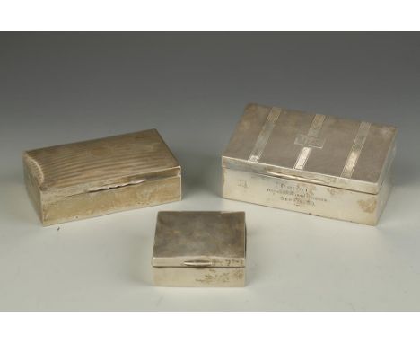 A TABLE CIGARETTE BOX, the sloping cover with engine-turned decoration, presentation engraved, Birmingham 1928, 7" long, and 