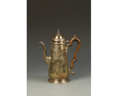 A GEORGE II COFFEE POT of tapering circular form, the domed hinged cover with graduated disc finial, wooden scroll handle and