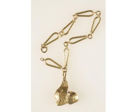 A YELLOW GOLD BRACELET, the oval engine turned links interspersed with circular links, with attached Egyptian style charm, c.