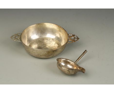 A GERMAN PORRINGER of circular tapering form, the lug handles pierced with heart motifs, the underside monogrammed and bearin