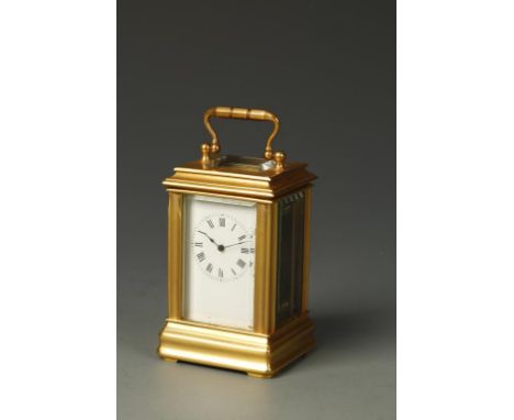 A FRENCH BRASS GORGE CASED MINIATURE CARRIAGE CLOCK, the white enamel dial with Roman numerals, the back plate with arrow mar