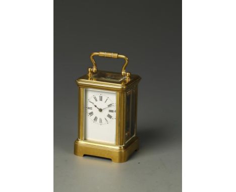 MAURICE AND CO': A FRENCH BRASS CASED MINIATURE CARRIAGE CLOCK, the white enamel dial with Roman numerals, the back plate num